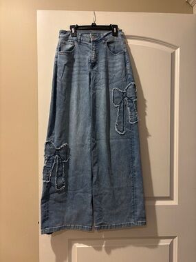 High-Rise Light Blue Wide-Leg Jeans with Frayed Bow Accents